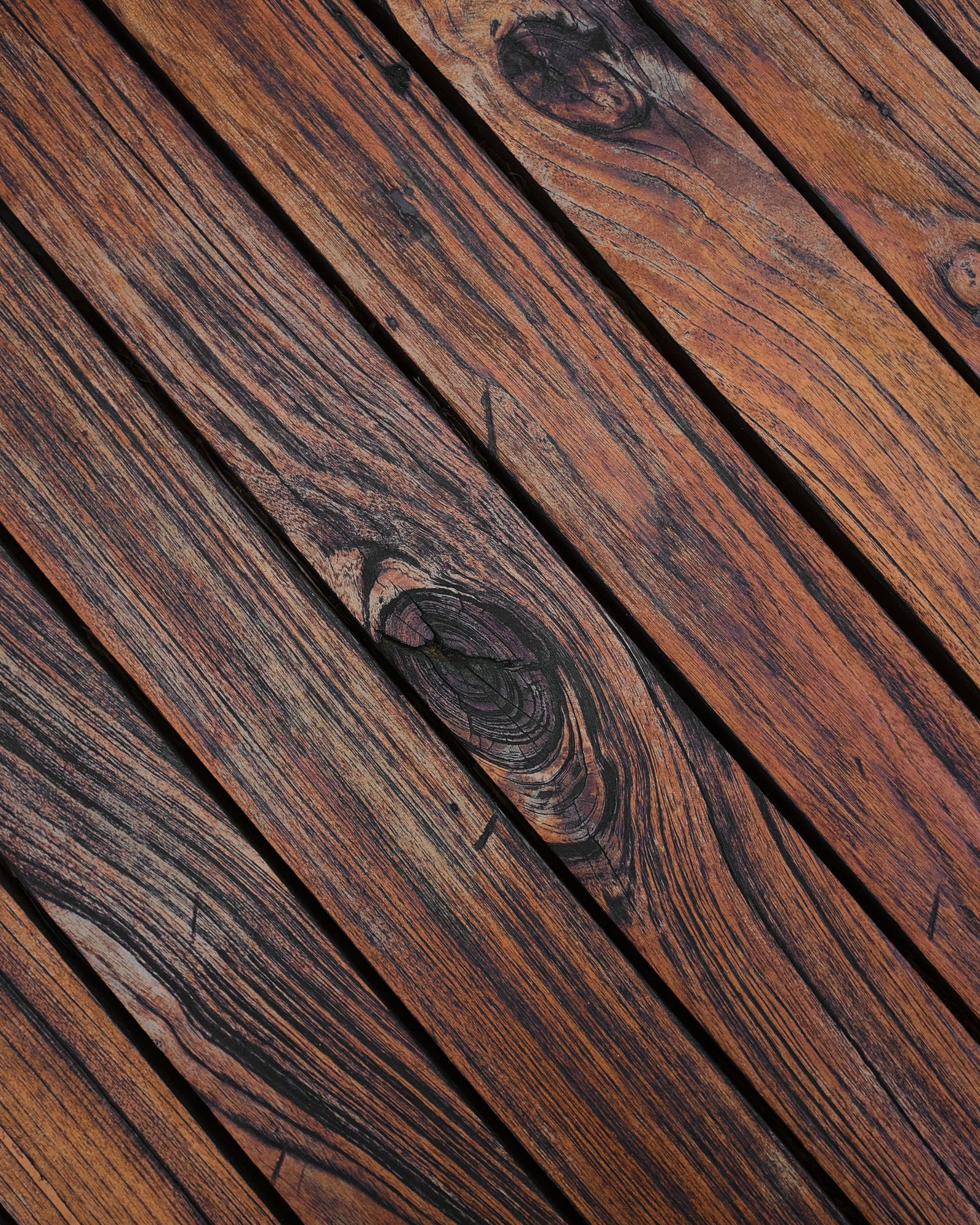 Close-up of weathered deck boards showing grain and greying