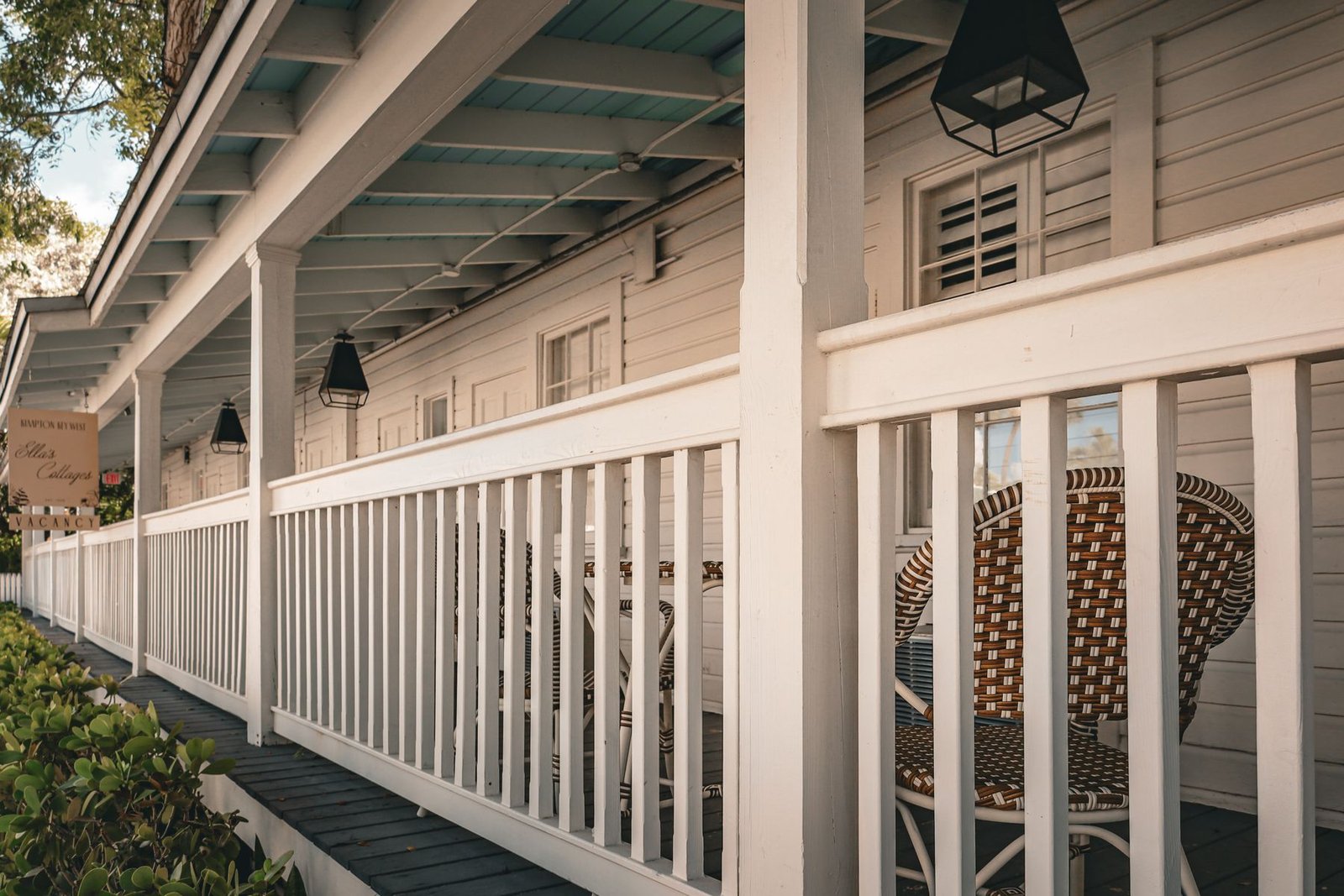 House porch with painted railing and wicker seating