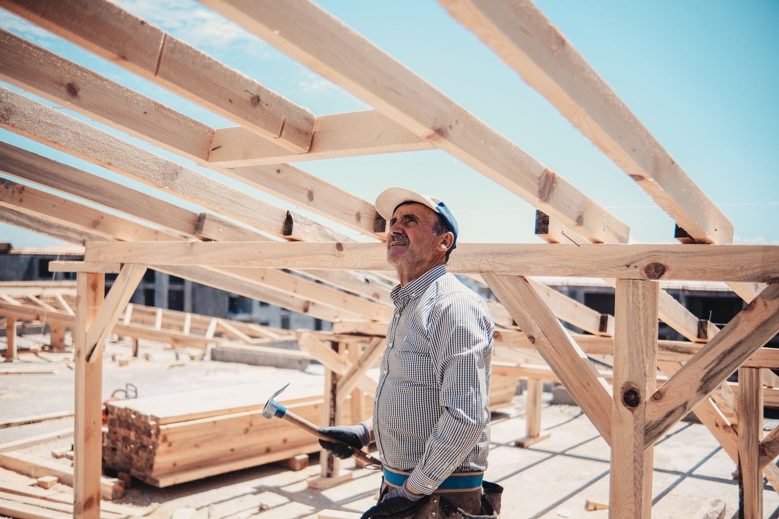 Worker checking a timber frame on a sunny day